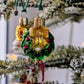 Suspension en verre soufflé, chromée et peinte à la main en forme de couronne de Noël verte décorée de boules de Noël rouges, de points de paillettes dorés et sertie d'un nœud doré. 